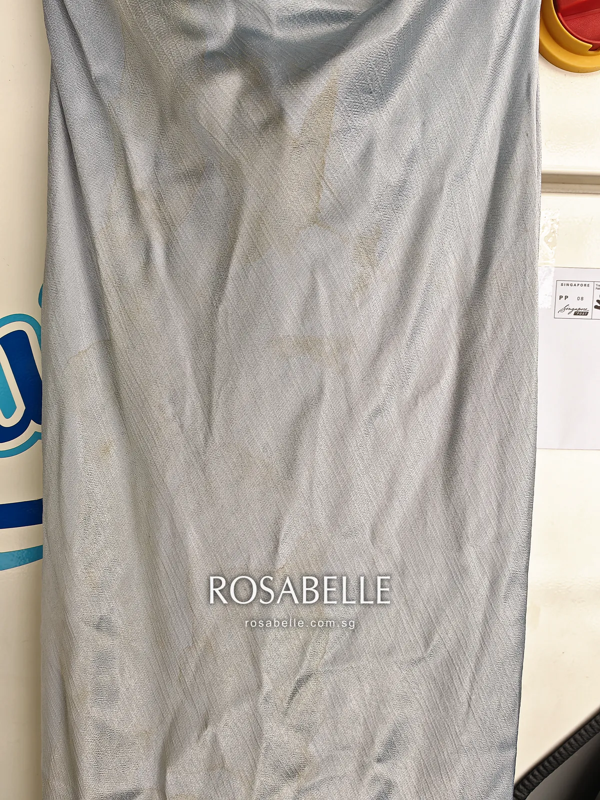 Skirt of the pale blue viscose dress with faint brown dye marks running down the front