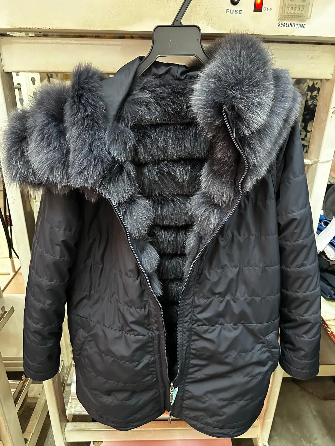 The same parka open, showing the full blue fox fur lining running the length of the jacket interior