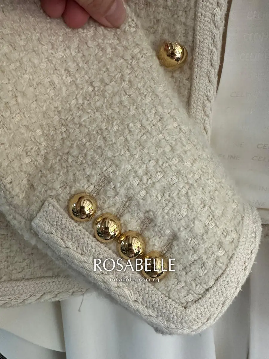 Close-up of the cleaned cuff and gold buttons of the Celine bouclé jacket after treatment
