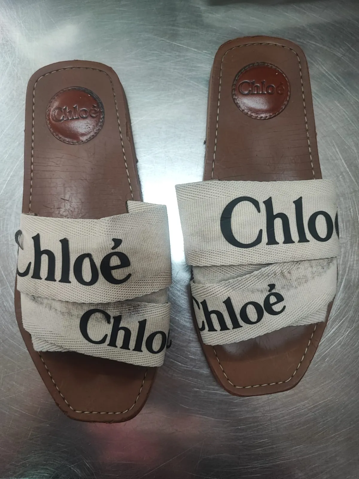 Chloé Woody flat sandals with greyed and soiled cream canvas logo straps before cleaning at Rosabelle Launderette Singapore