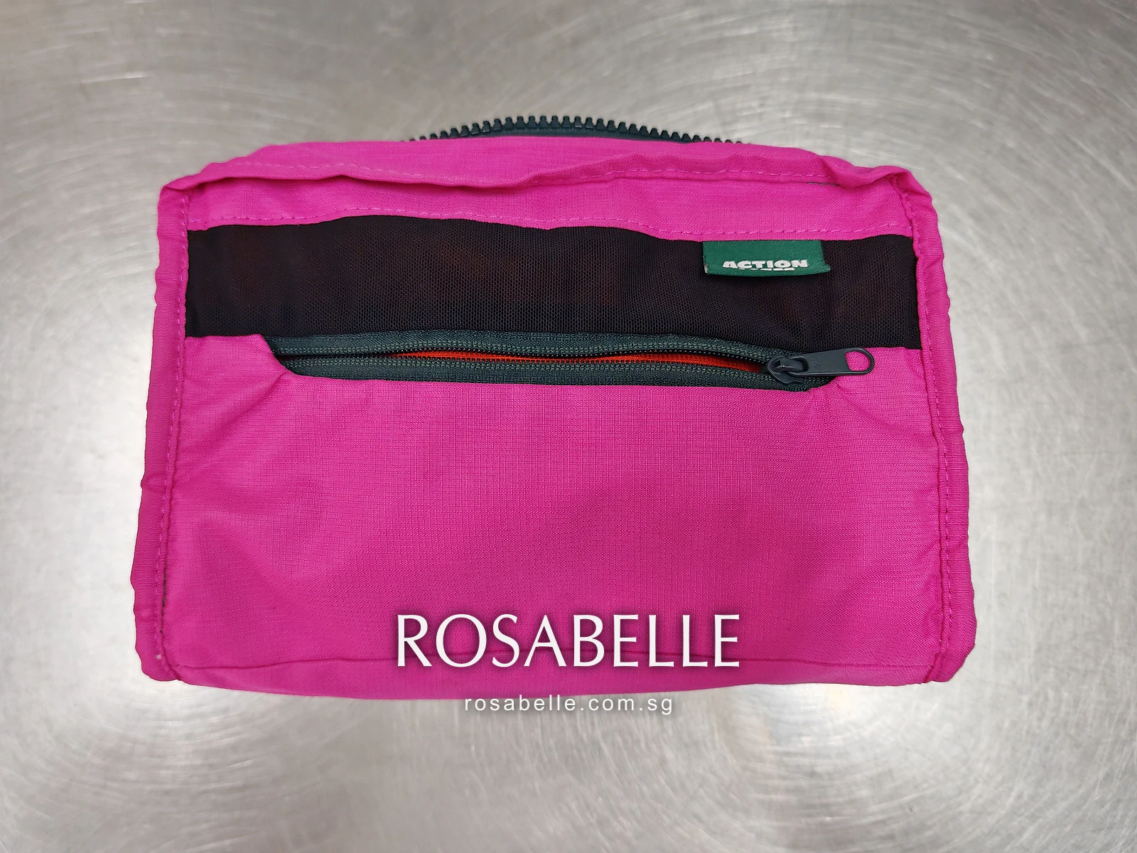 Bright pink lining of the bag with a black mesh zip pocket and a small green maker's label, before cleaning