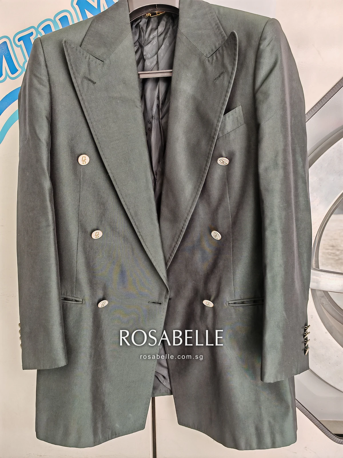 Green Dolce and Gabbana double-breasted silk coat on a hanger with peak lapels and logo buttons, before oil removal