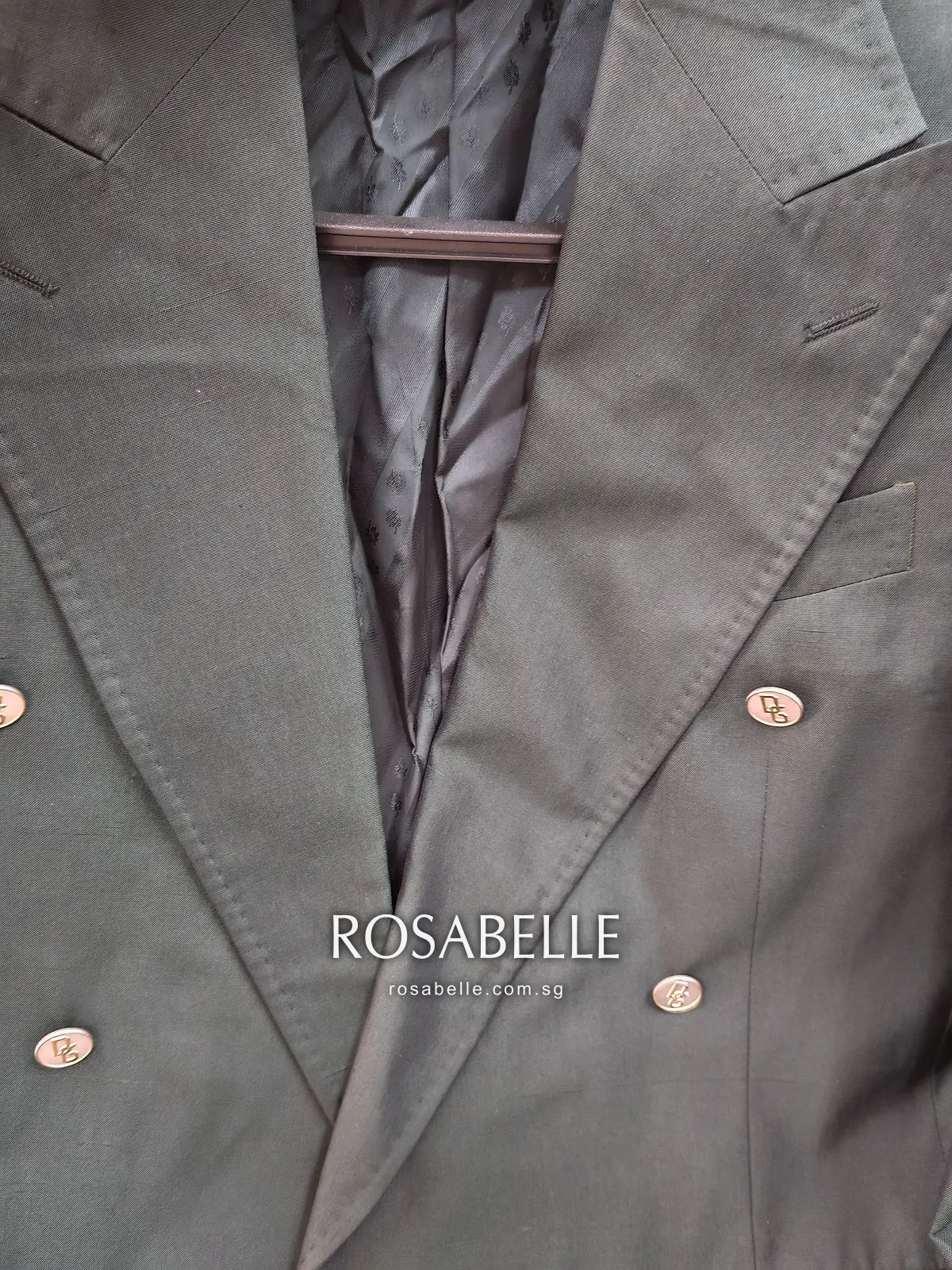 Left lapel of the green silk coat before cleaning, a faint darker area of coconut oil below the lapel buttonhole