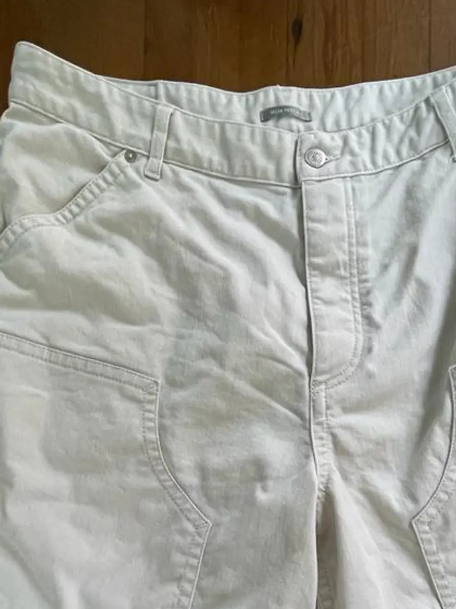 Close-up of the same waistband and front pocket with an even cream colour after treatment at Rosabelle Launderette