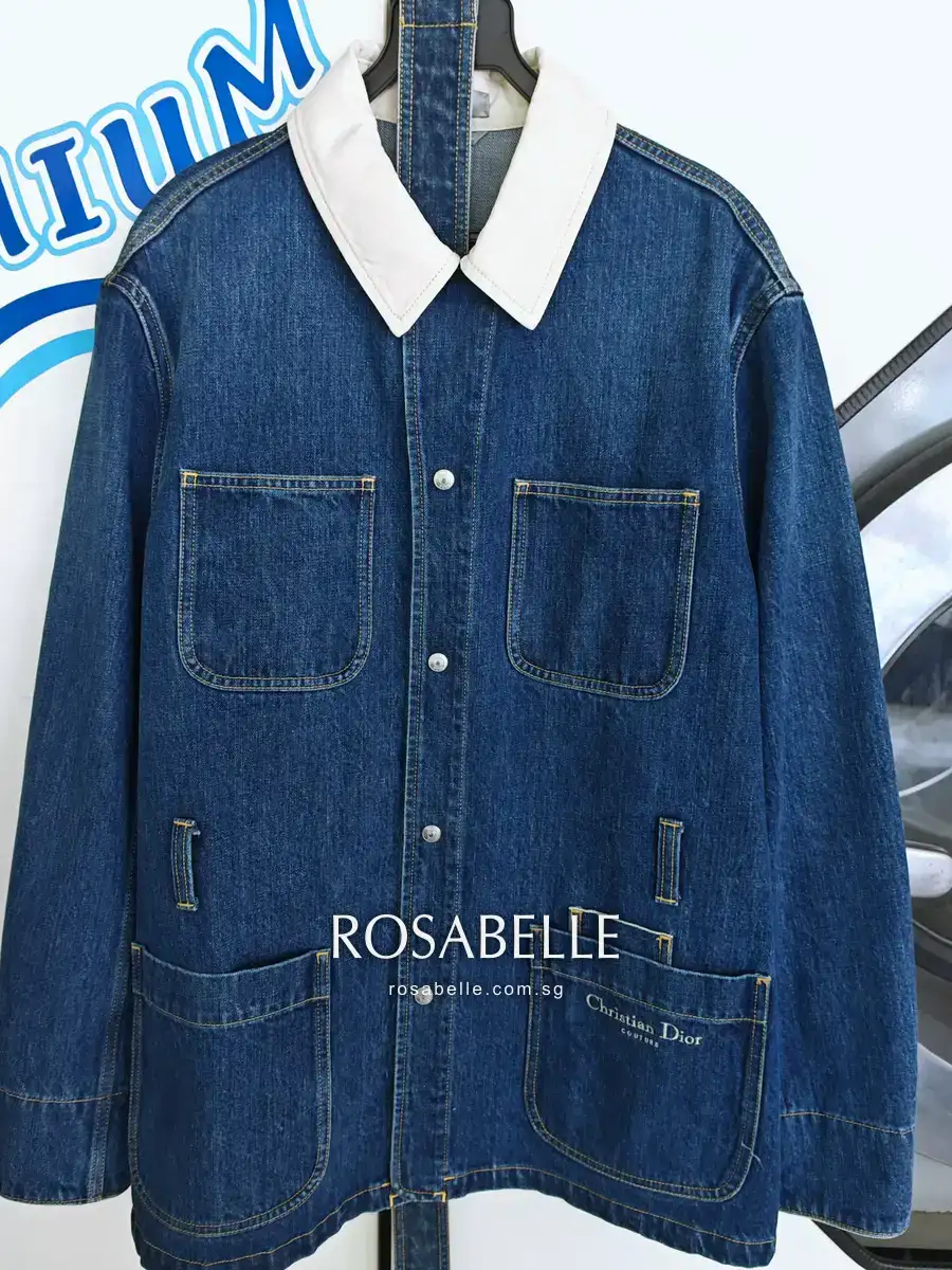The same Dior denim jacket after cleaning at Rosabelle Launderette Singapore, the cream collar an even colour again and the indigo denim showing no patchiness or lightened seams