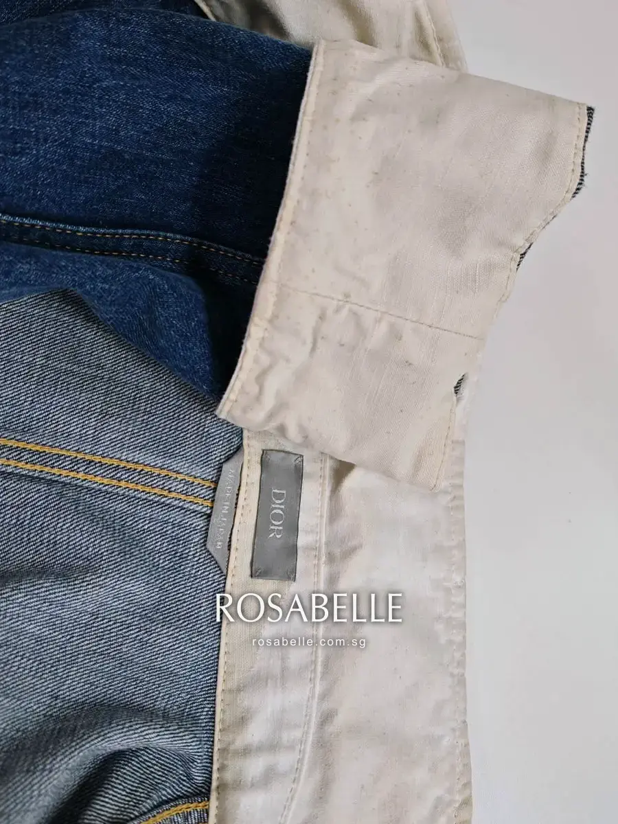 A cream cotton cuff facing on a Dior denim jacket before cleaning at Rosabelle Launderette Singapore, yellowed with brown speckles across the cloth