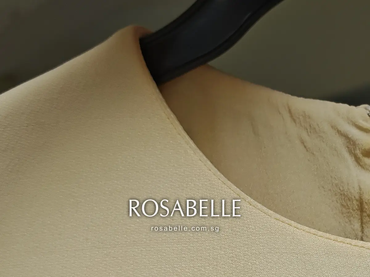 Neckline of the Dior dress after cleaning, a clean edge with the creased silk lining of the back visible through it