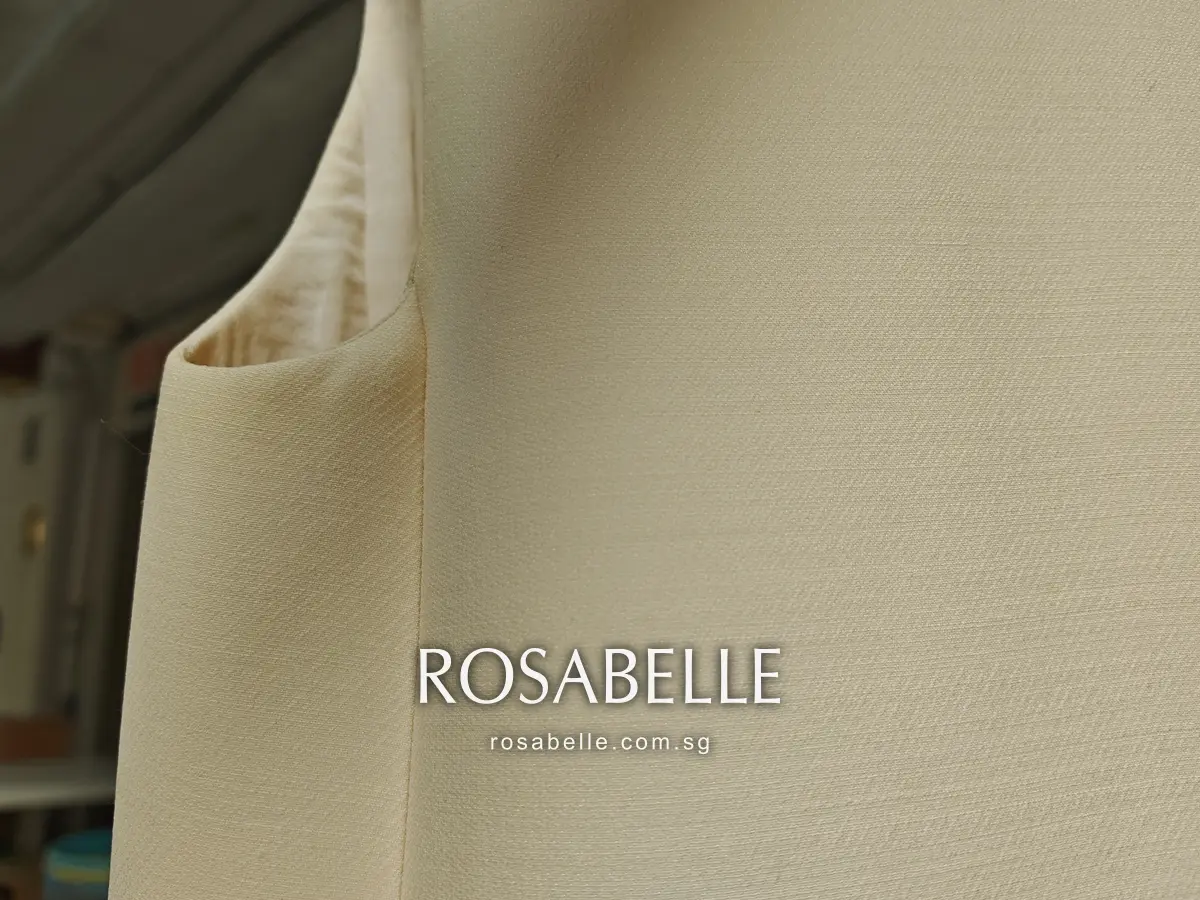 Dior dress armhole after cleaning, seen hanging, the edge clean where the ring had been and the silk lining visible