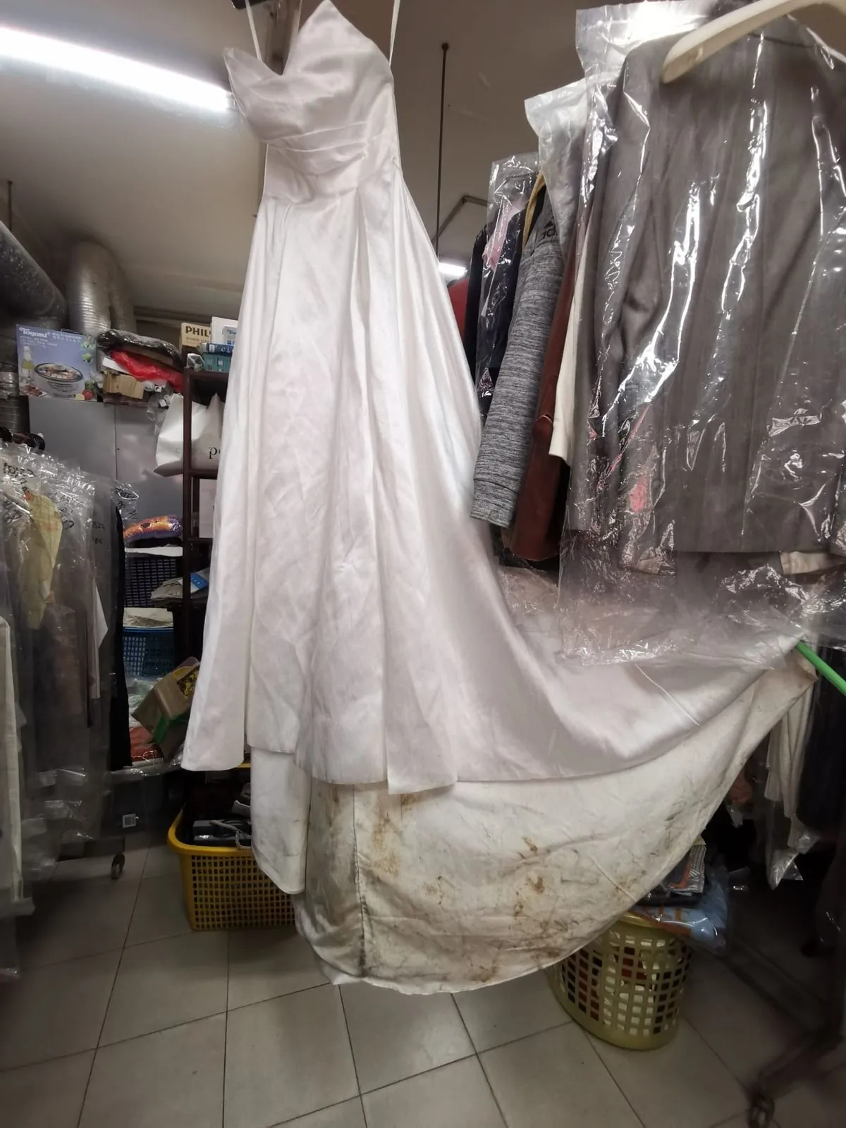 Wedding gown with mud-stained train before restoration — Rosabelle Launderette case study