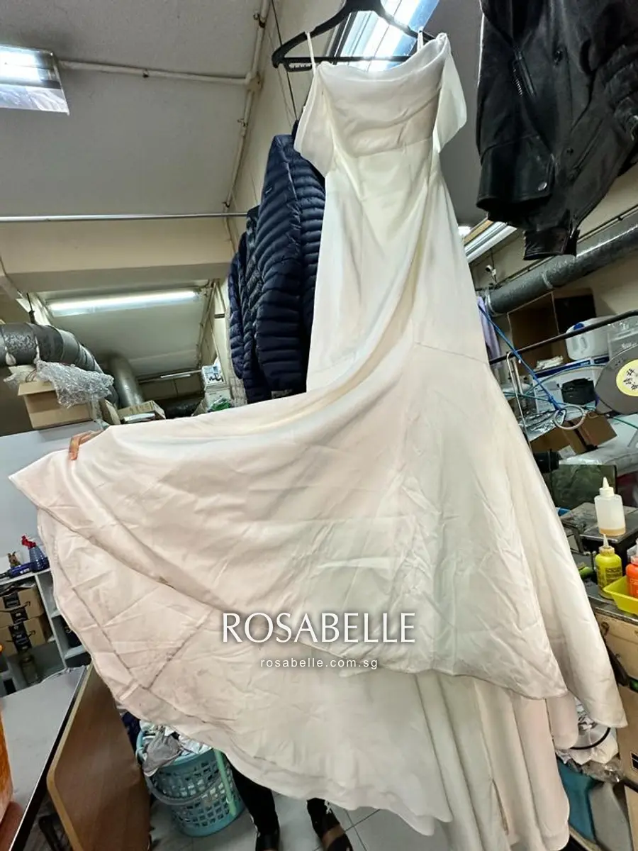 Wedding gown with a long train before the soiled hem was cleaned