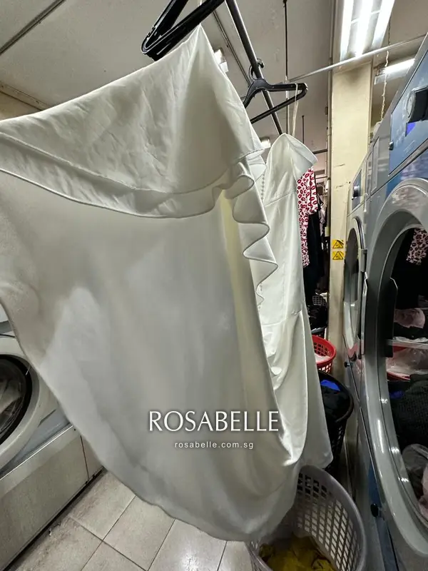 The scalloped underlayer edge beneath the satin, the part that greyed first