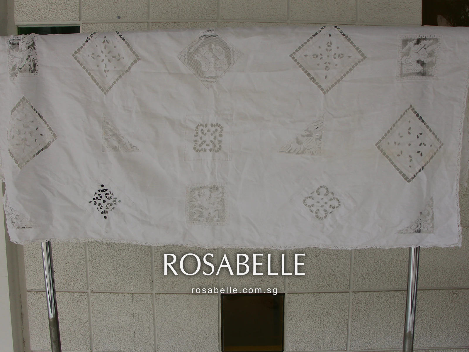 Cutwork tablecloth turned the other way after cleaning, the open diamonds and filet lace corners clean