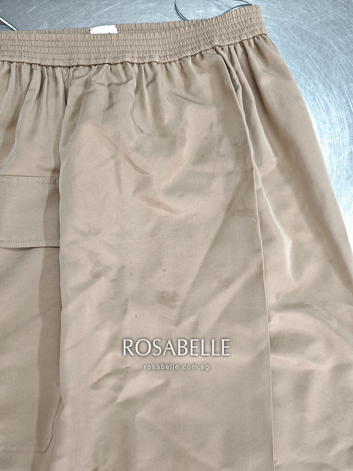 Back of the Hermès silk skirt before cleaning, small darker spots across the lower half of the panel