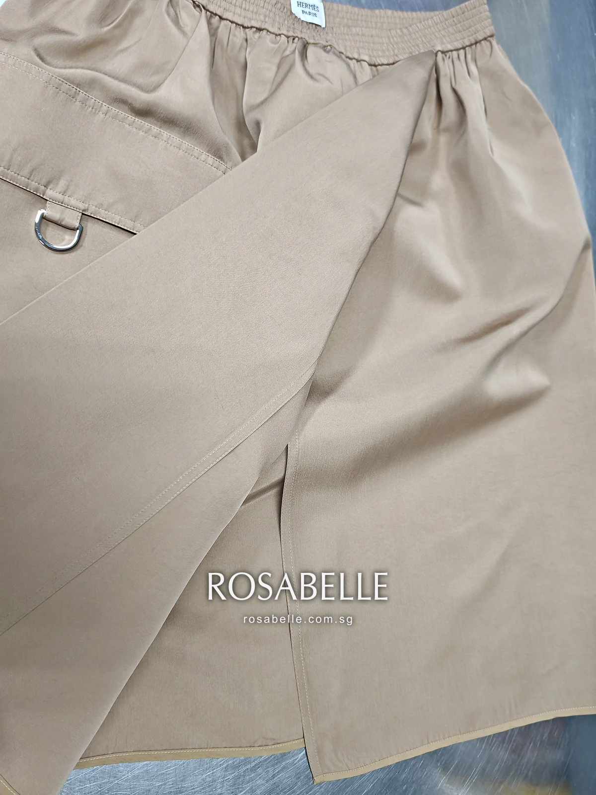 The wrap panel of the Hermès skirt after cleaning, the silk even beside the pocket and its metal D-ring