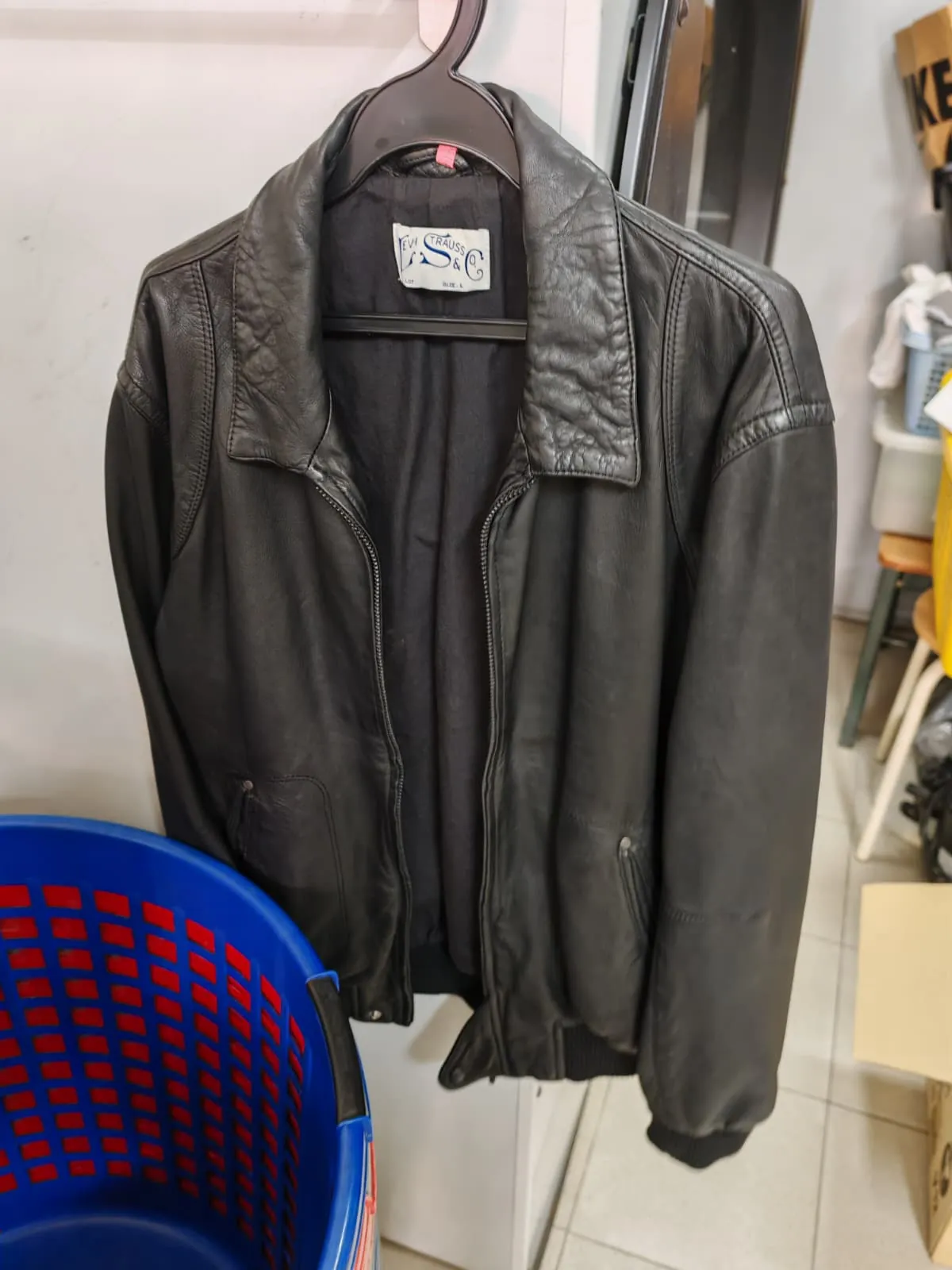 Vintage Levi's black leather jacket looking dull and flat before cleaning and odour treatment at Rosabelle Launderette Singapore