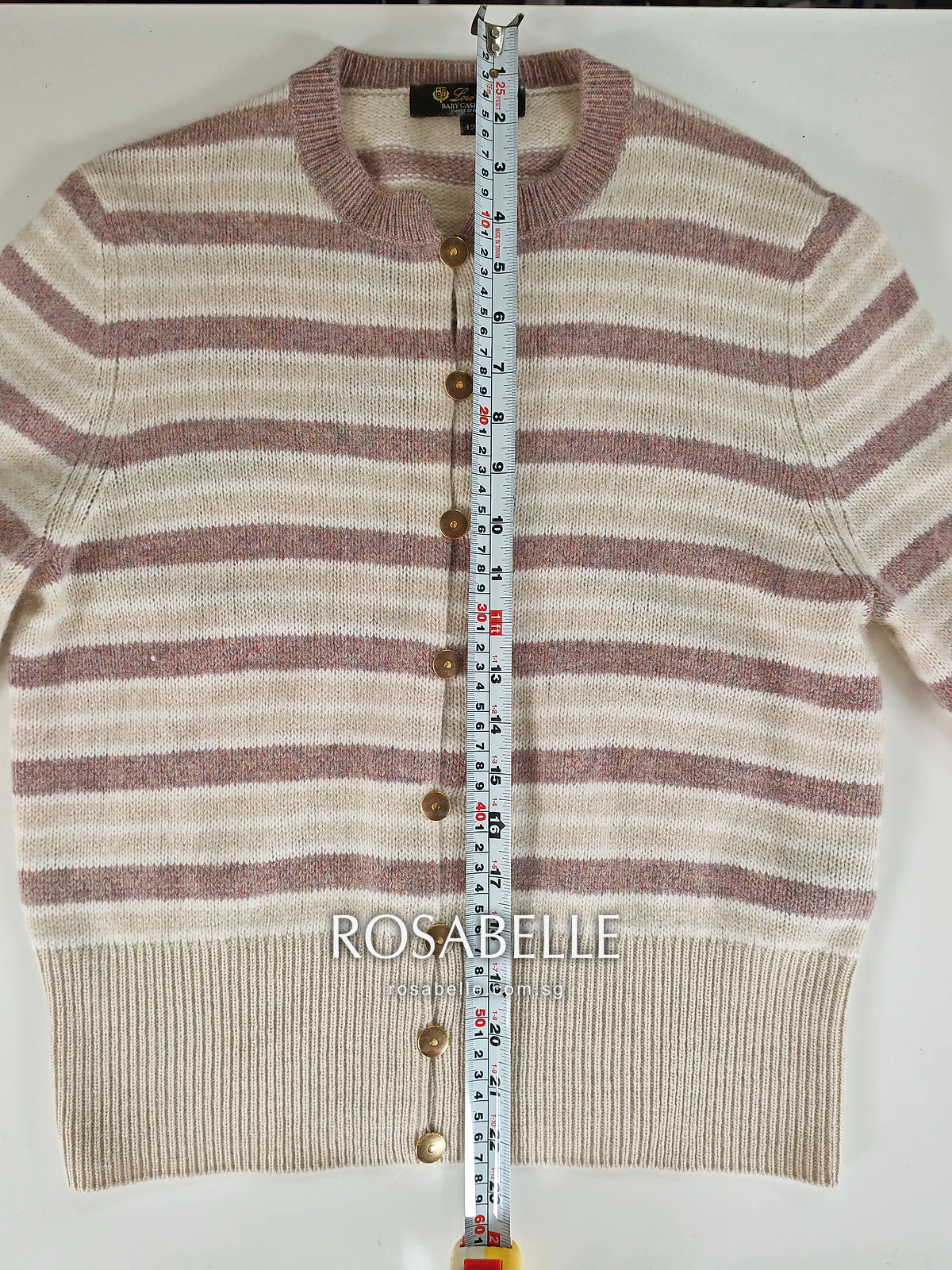 The same striped cashmere cardigan after reblocking, tape along the button placket from neckline to the bottom of the hem rib