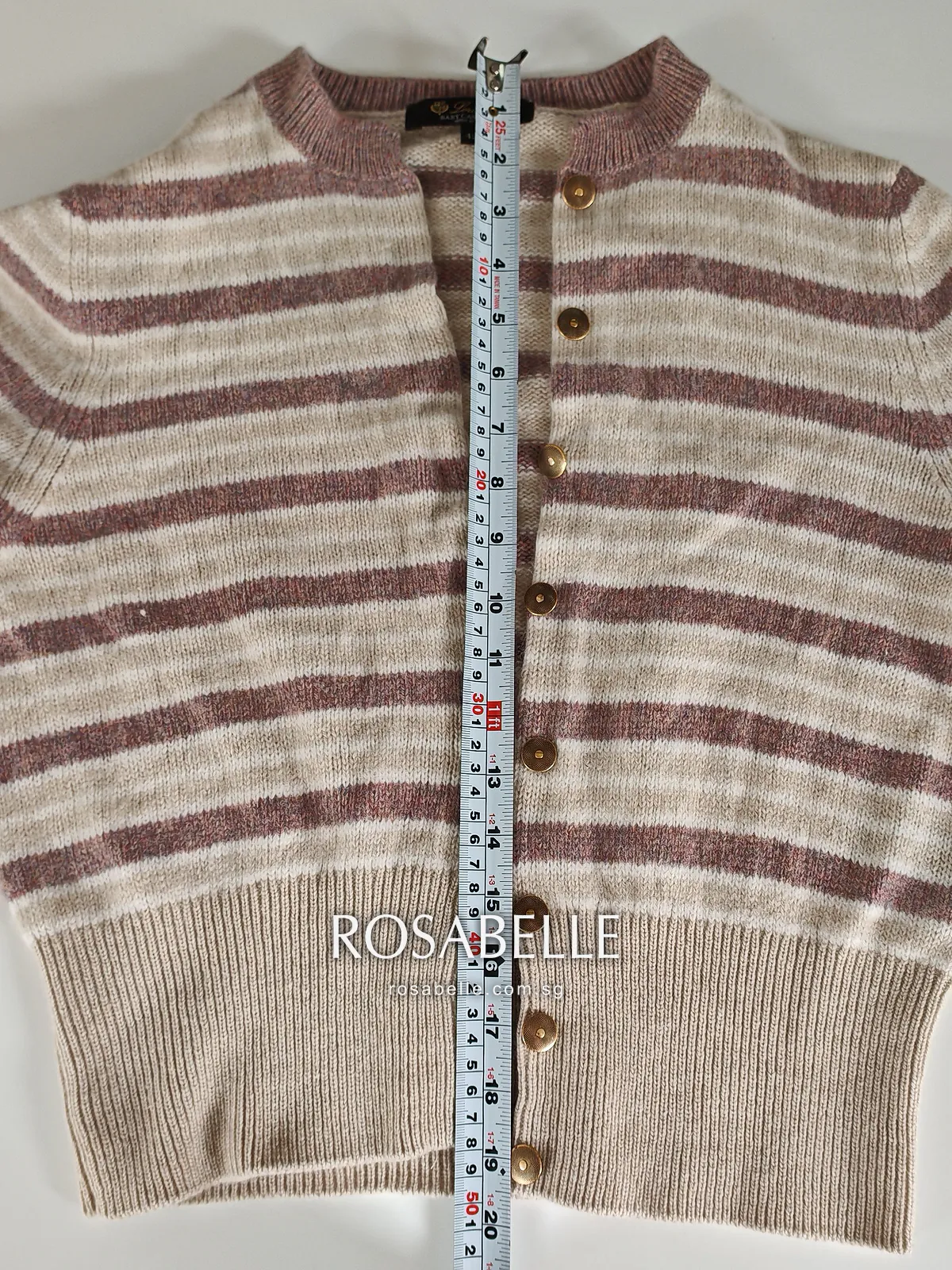 Striped Loro Piana cashmere cardigan laid flat, a tape measure running from the ribbed collar to the deep ribbed hem along the buttons