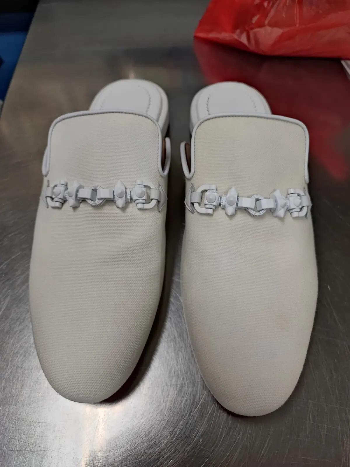 The same Christian Louboutin canvas mules cleaned back to an even off-white after hand cleaning at Rosabelle Launderette Singapore