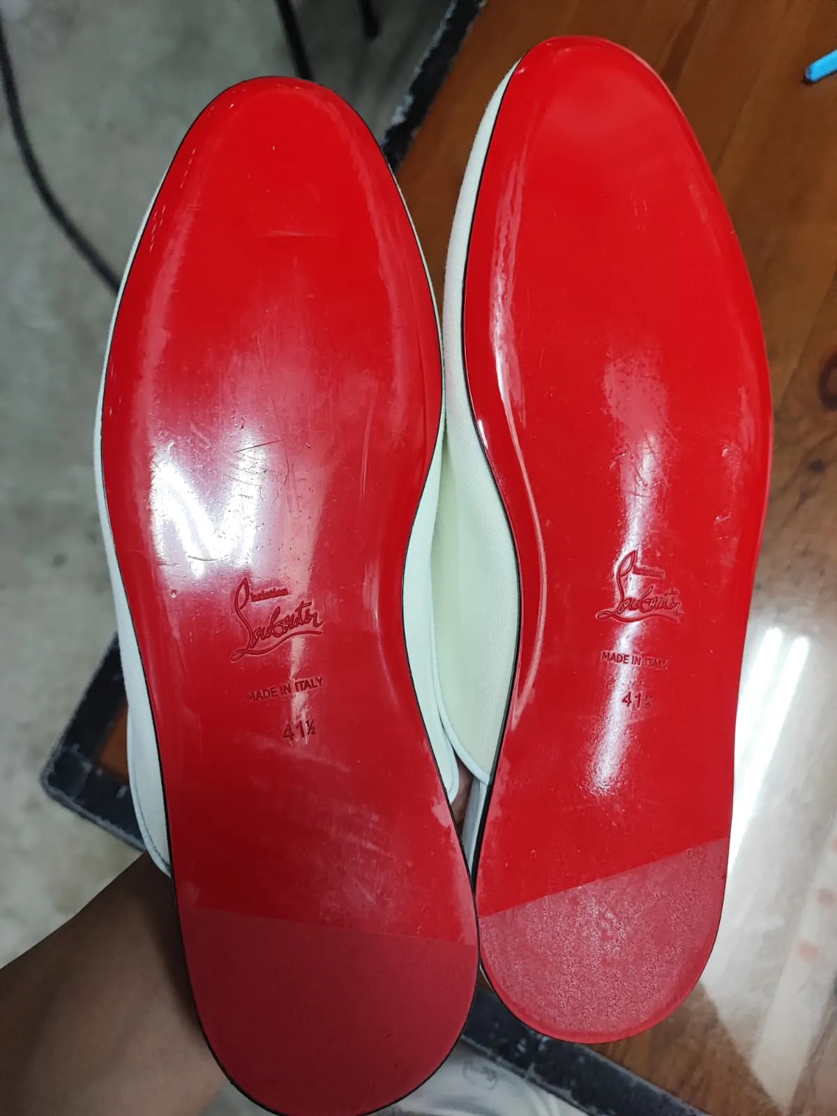 The same Christian Louboutin red soles cleaned and buffed back to full gloss at Rosabelle Launderette