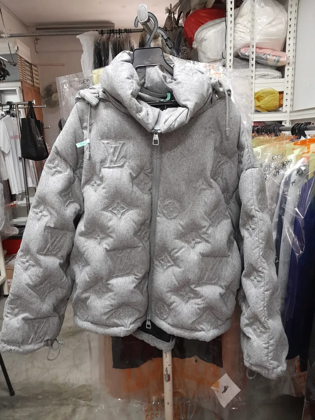 The same Louis Vuitton monogram down puffer after cleaning, with full loft restored and the embossed LV monogram crisp, at Rosabelle Launderette Singapore
