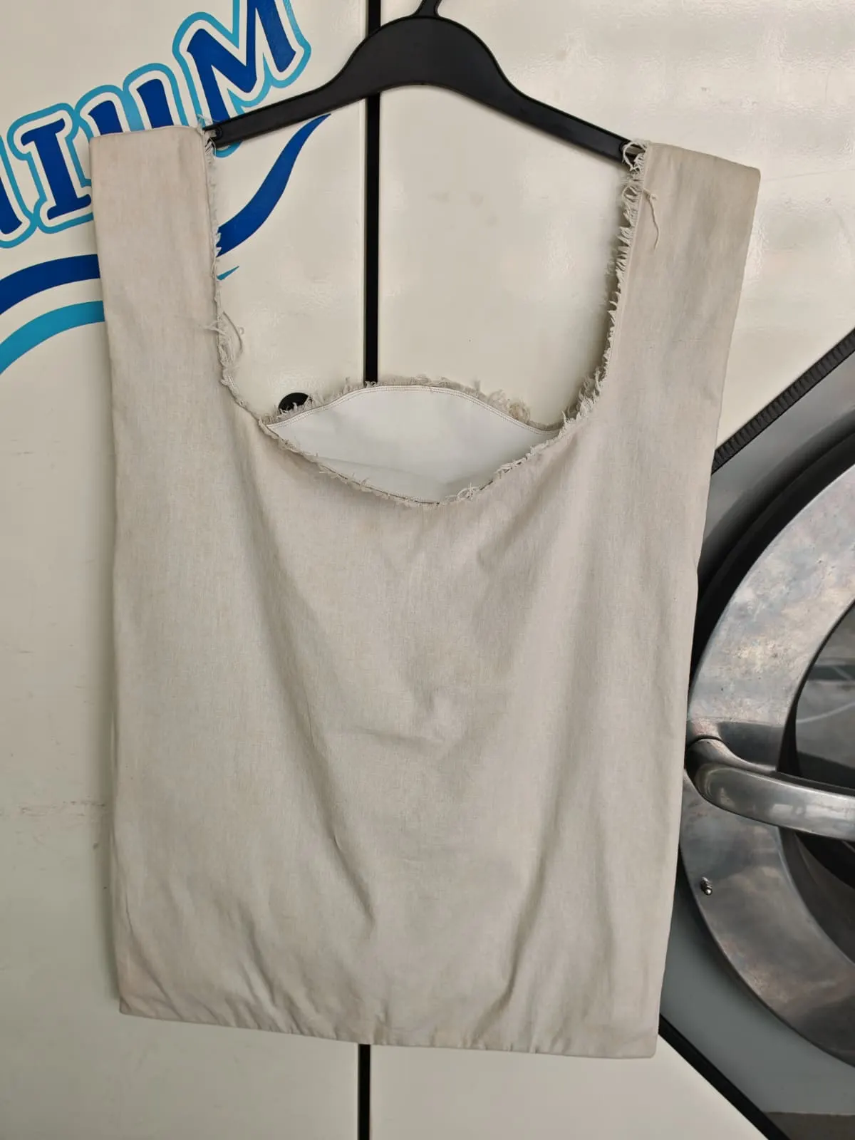 The same Maison Margiela shopping tote substantially recovered to a clean off-white after specialist treatment at Rosabelle Launderette Singapore