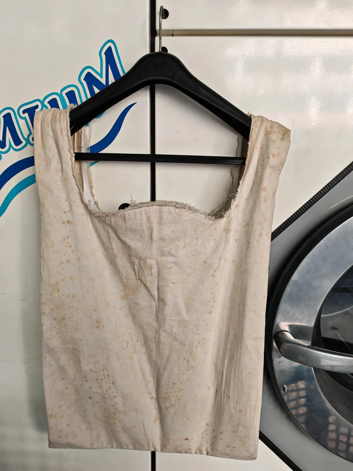 Reverse side of the Maison Margiela tote showing widespread yellow oxidation spots before cleaning
