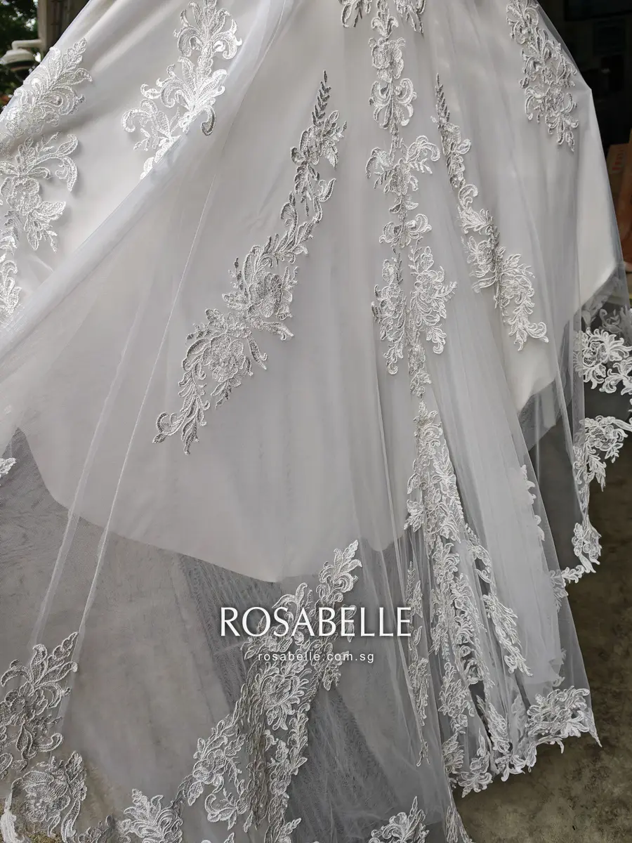 Tulle train of the gown with separate lace sprays stitched on at intervals down its length