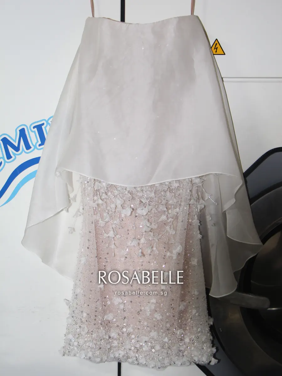 The same mini dress after cleaning, the chiffon shell hanging evenly and the beaded underskirt visible below it