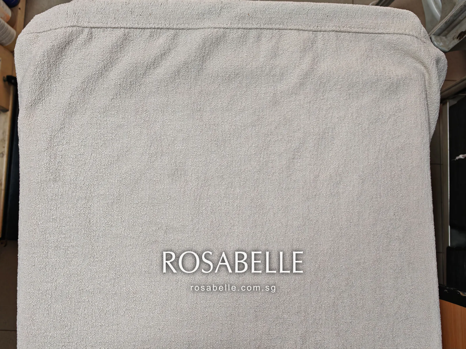 The same style of cream cushion cover after cleaning, fitted on its cushion with the pile an even pale cream edge to edge