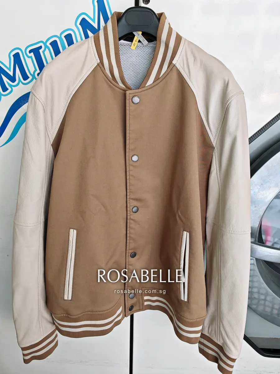 Strellson snap-front jacket on a hanger before cleaning, pale lambskin raglan sleeves against a camel body