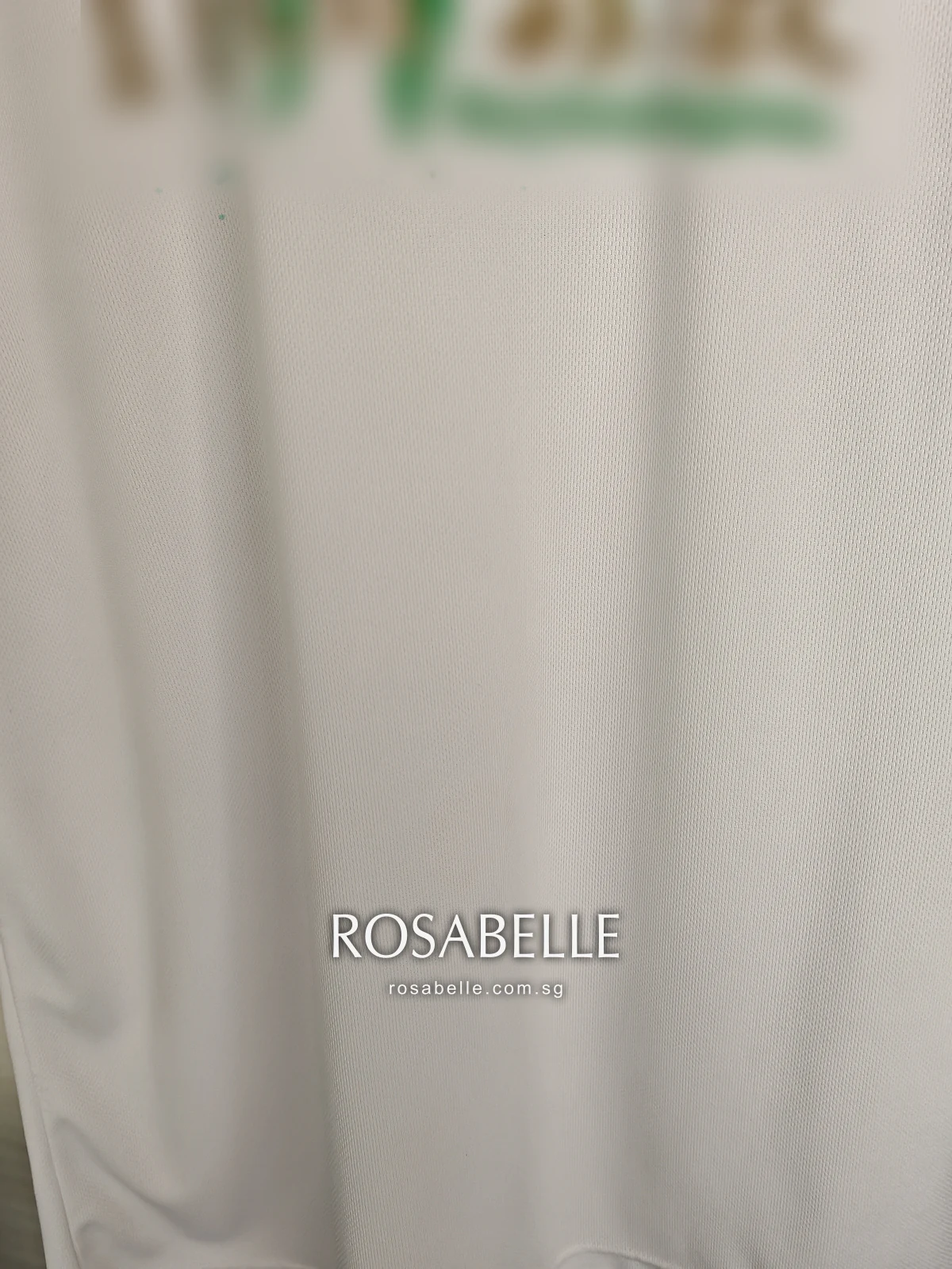 Close view of the front of the T-shirt after cleaning, the white polyester mesh clear and even