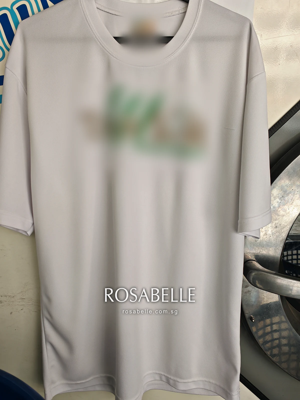 The same white T-shirt on a hanger after cleaning, the front an even white from chest to hem