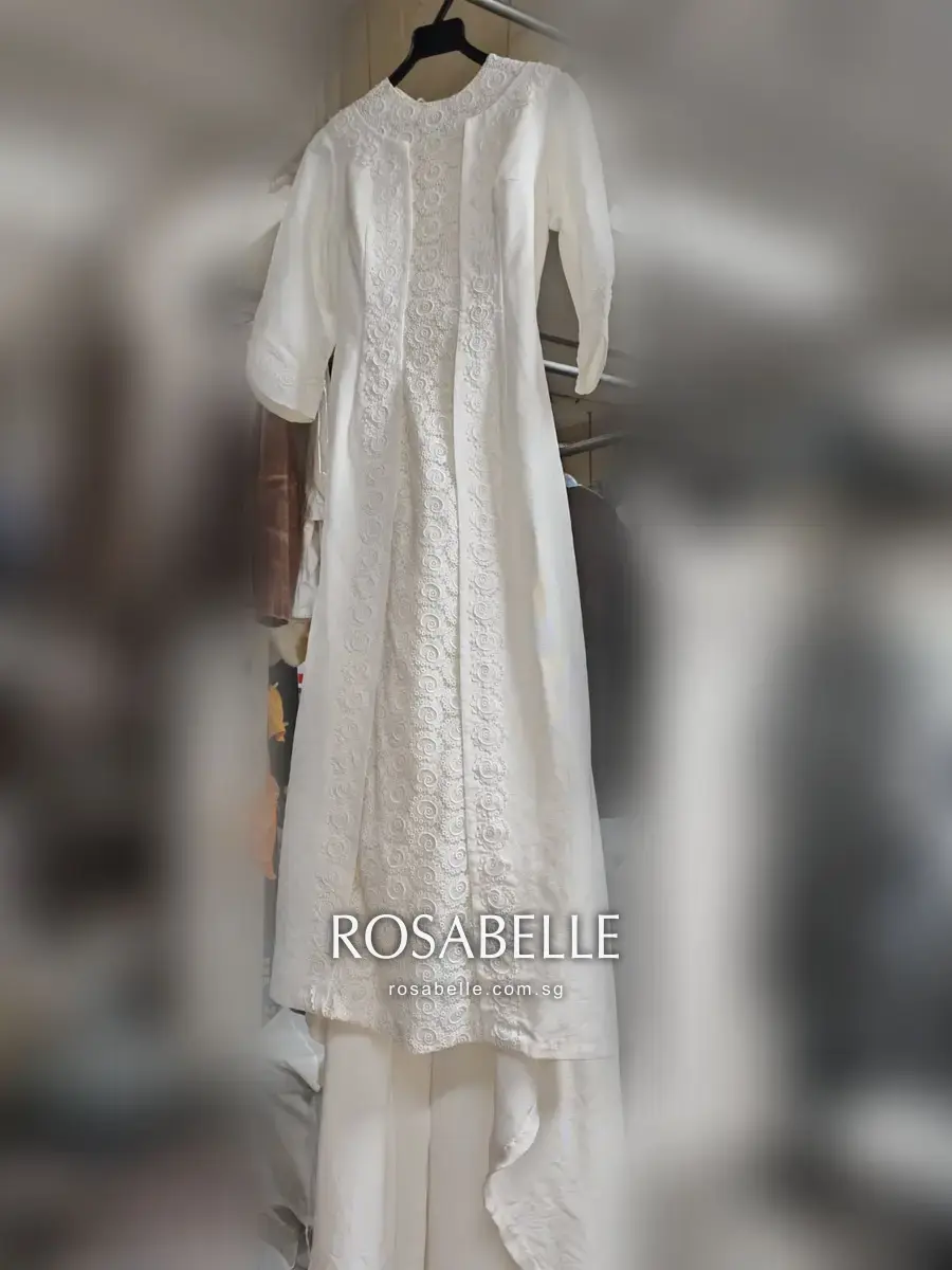 A 1970s ivory silk wedding gown with a cutwork lace panel, in for a routine clean at Rosabelle Launderette Singapore