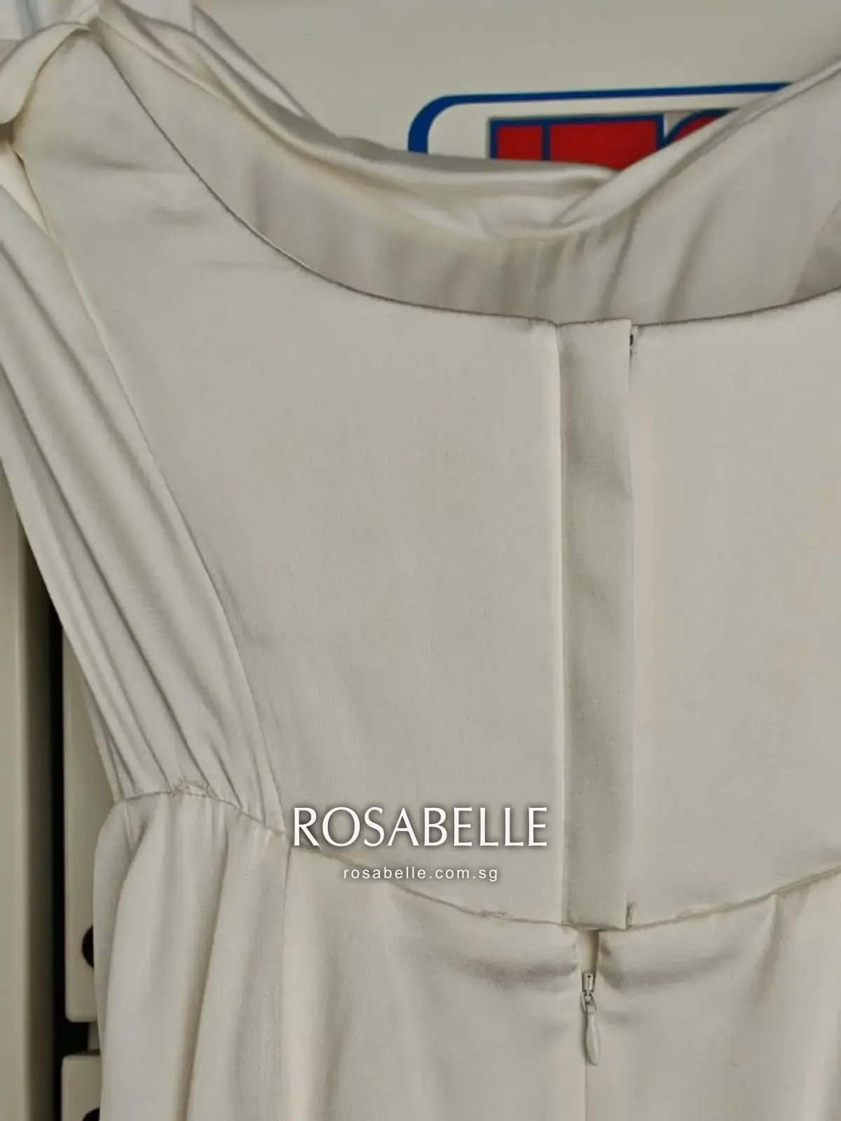 The bodice and knotted cap sleeve, panel seams sitting flat and the ivory unmarked