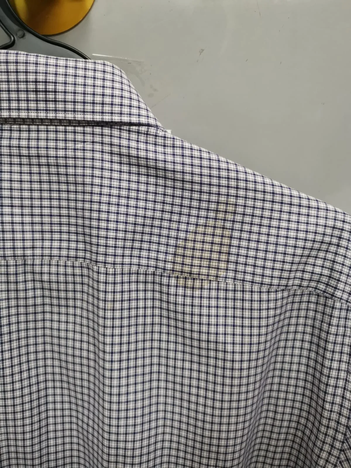 Close-up of yellow oxidised stain on the back yoke of the Zegna shirt before treatment